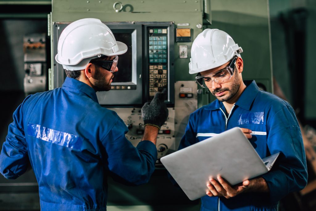 industry engineer team worker operate control heavy machine with computer laptop to help analysis operating problem.